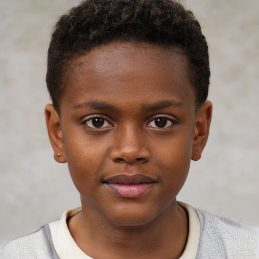Joyful black child male with short  brown hair and brown eyes