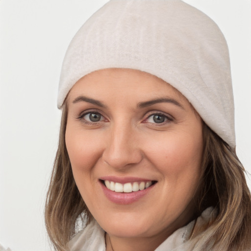 Joyful white young-adult female with medium  brown hair and blue eyes