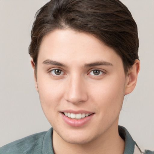 Joyful white young-adult female with short  brown hair and grey eyes