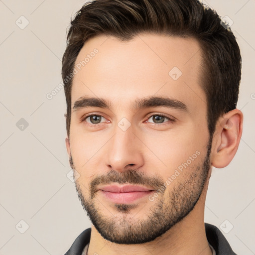 Joyful white young-adult male with short  brown hair and brown eyes