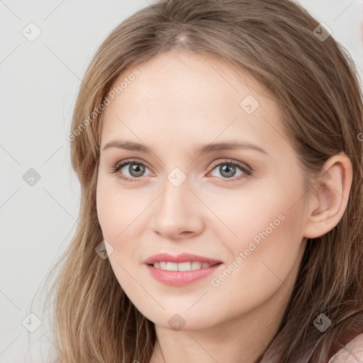 Joyful white young-adult female with long  brown hair and blue eyes