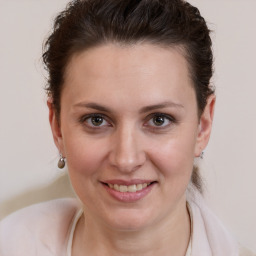 Joyful white young-adult female with medium  brown hair and grey eyes