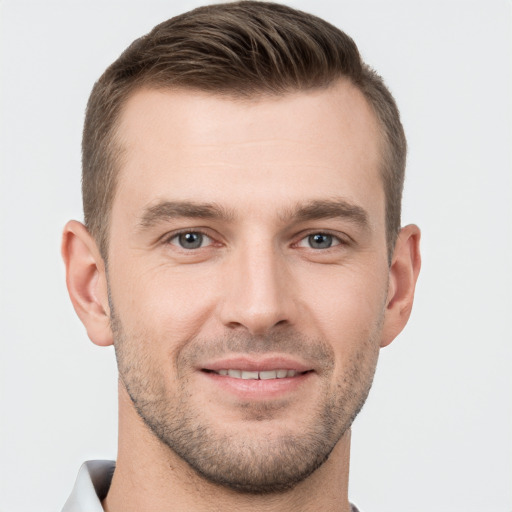 Joyful white young-adult male with short  brown hair and brown eyes