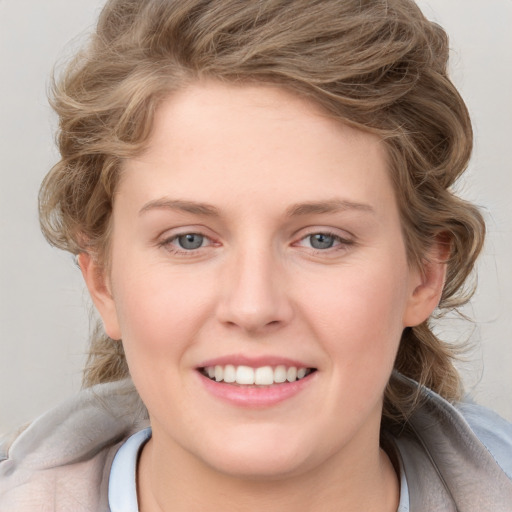 Joyful white young-adult female with medium  brown hair and blue eyes