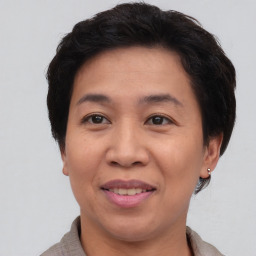 Joyful asian adult female with short  brown hair and brown eyes