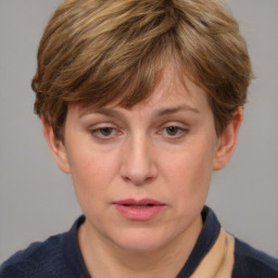 Joyful white adult female with medium  brown hair and grey eyes