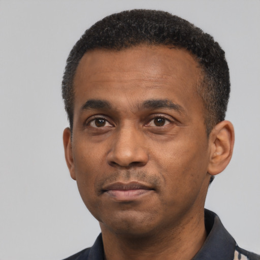 Neutral latino adult male with short  black hair and brown eyes