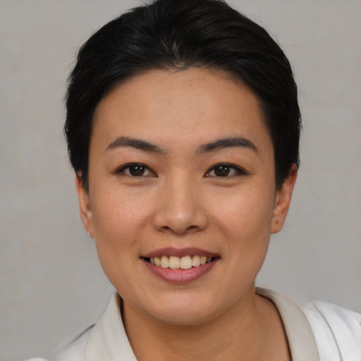 Joyful asian young-adult female with short  black hair and brown eyes
