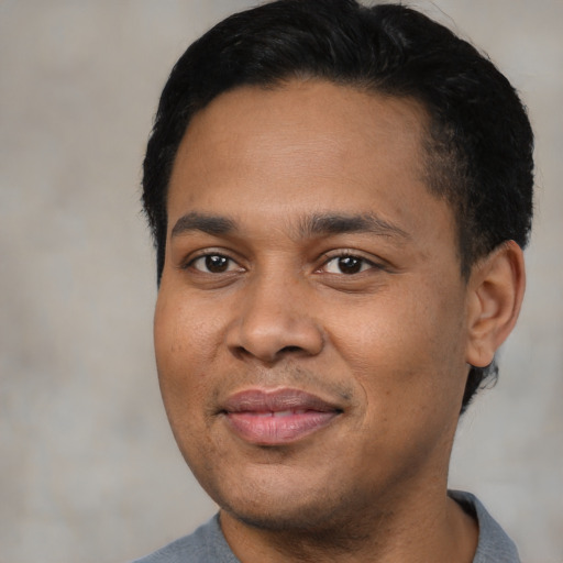 Joyful latino young-adult male with short  black hair and brown eyes