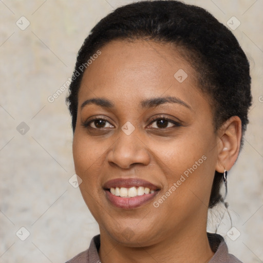 Joyful black young-adult female with short  black hair and brown eyes