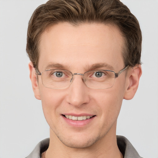 Joyful white adult male with short  brown hair and grey eyes