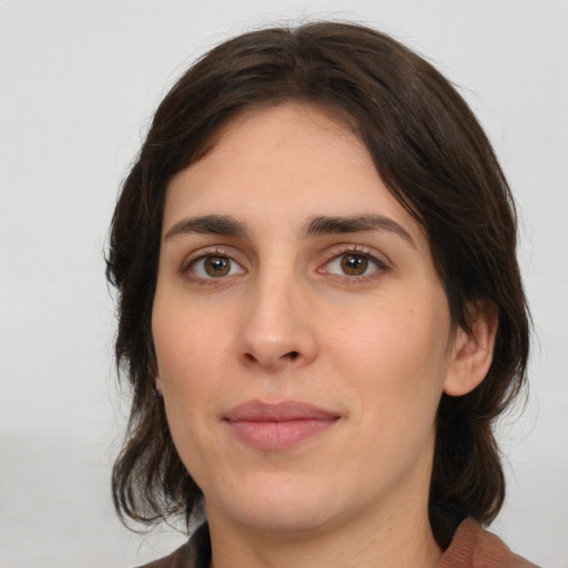 Joyful white young-adult female with medium  brown hair and brown eyes