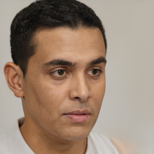Neutral latino young-adult male with short  brown hair and brown eyes