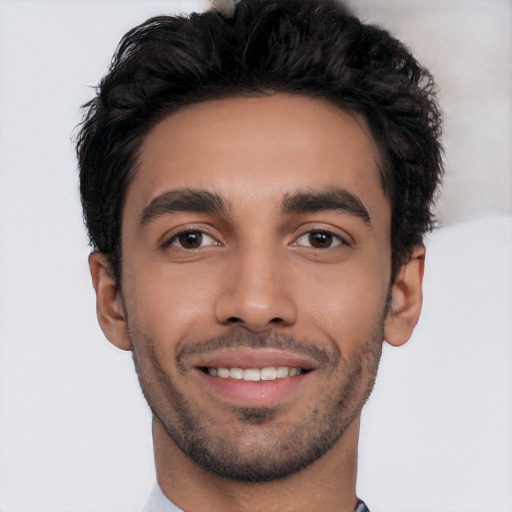 Joyful white young-adult male with short  black hair and brown eyes