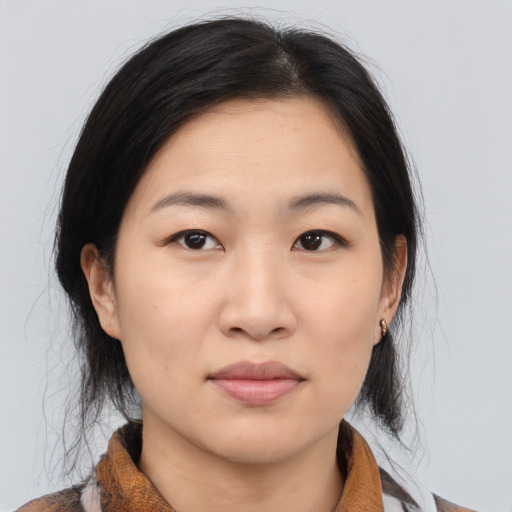 Joyful asian young-adult female with medium  brown hair and brown eyes