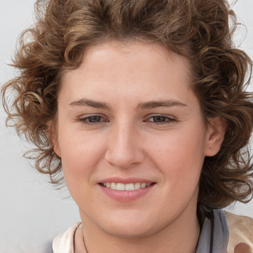 Joyful white young-adult female with medium  brown hair and blue eyes