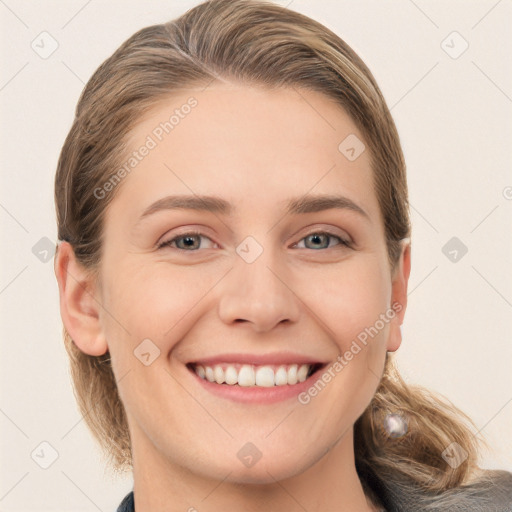 Joyful white young-adult female with long  brown hair and grey eyes