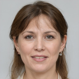 Joyful white adult female with medium  brown hair and grey eyes