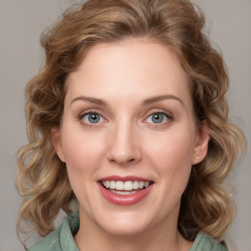 Joyful white young-adult female with medium  brown hair and blue eyes