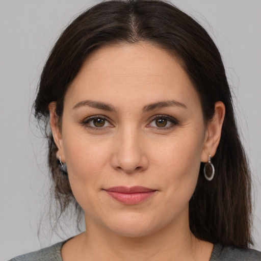 Joyful white adult female with medium  brown hair and brown eyes