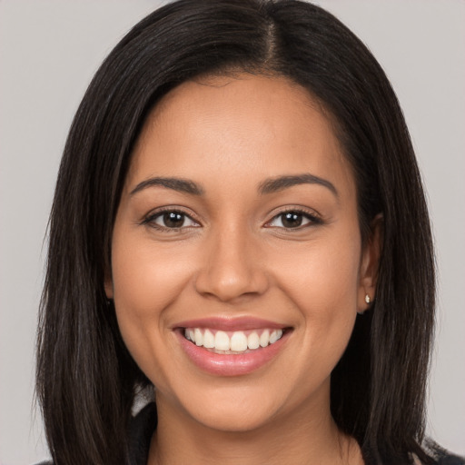 Joyful white young-adult female with long  brown hair and brown eyes