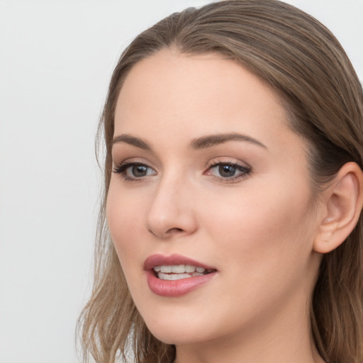 Joyful white young-adult female with long  brown hair and grey eyes