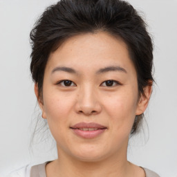 Joyful asian young-adult female with medium  brown hair and brown eyes