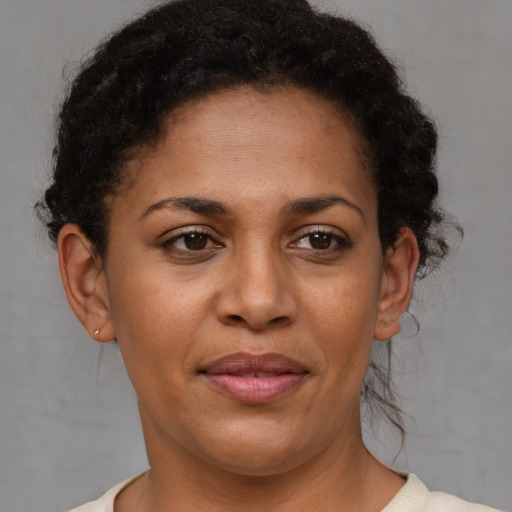 Joyful black adult female with short  brown hair and brown eyes