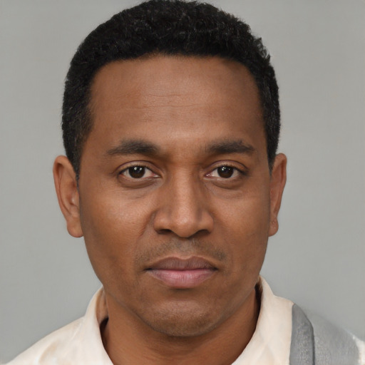 Neutral black young-adult male with short  black hair and brown eyes