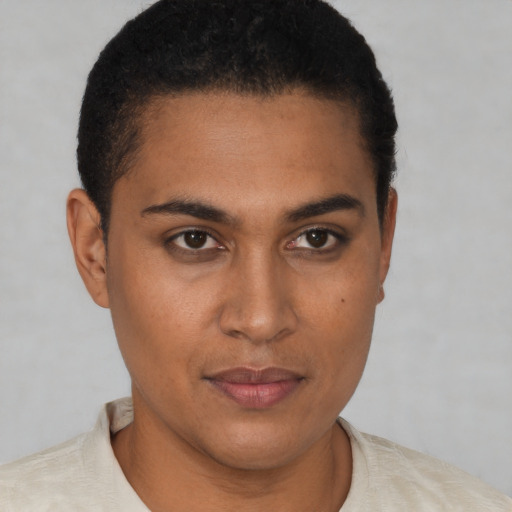 Joyful black young-adult male with short  brown hair and brown eyes