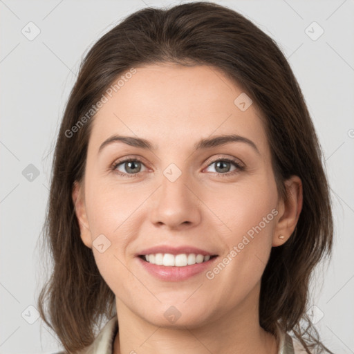 Joyful white young-adult female with medium  brown hair and grey eyes