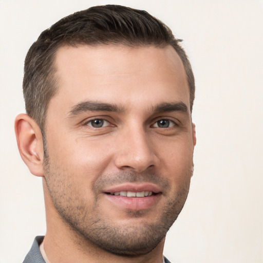 Joyful white young-adult male with short  brown hair and brown eyes