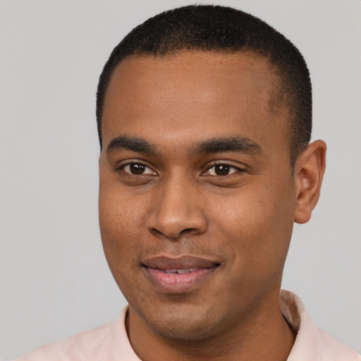 Joyful black young-adult male with short  black hair and brown eyes