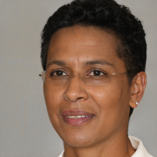 Joyful black adult female with short  brown hair and brown eyes