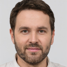 Joyful white adult male with short  brown hair and brown eyes