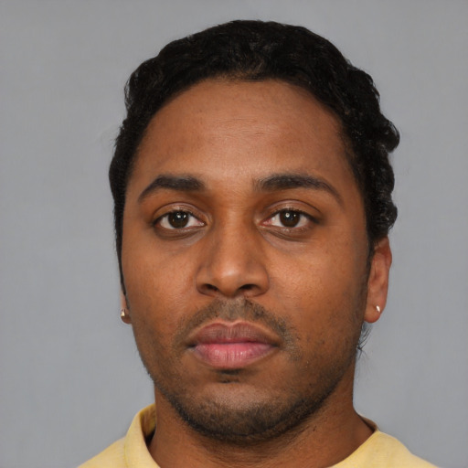 Neutral latino young-adult male with short  black hair and brown eyes