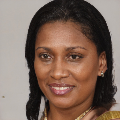 Joyful black adult female with medium  brown hair and brown eyes