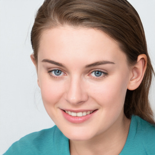 Joyful white young-adult female with medium  brown hair and blue eyes