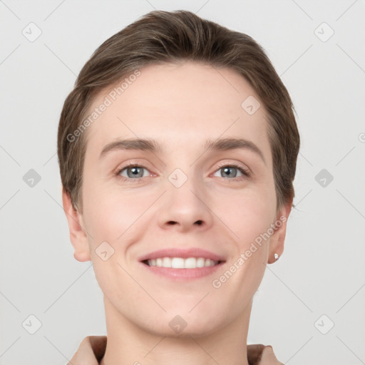 Joyful white young-adult female with short  brown hair and grey eyes