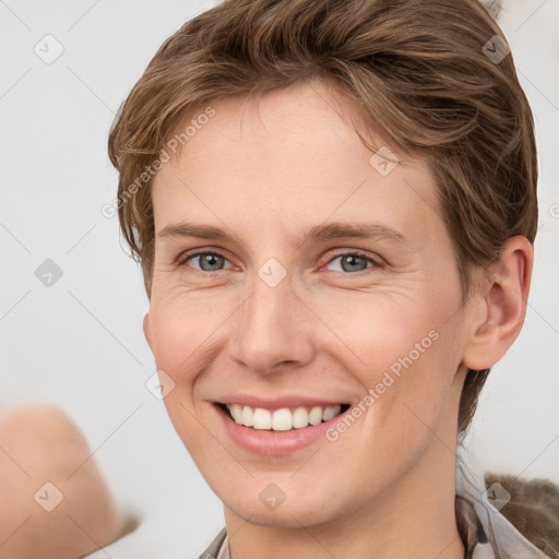 Joyful white young-adult female with short  brown hair and grey eyes