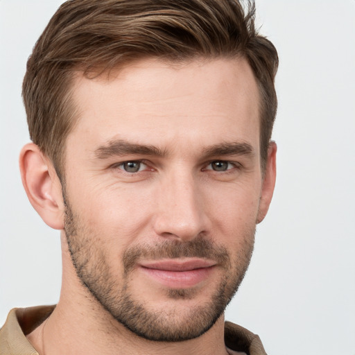 Joyful white young-adult male with short  brown hair and grey eyes