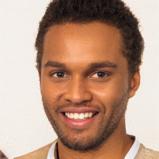 Joyful black young-adult male with short  brown hair and brown eyes