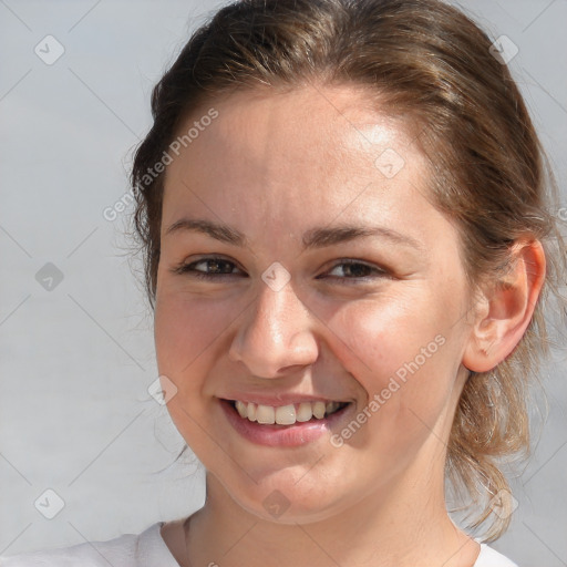 Joyful white young-adult female with medium  brown hair and blue eyes