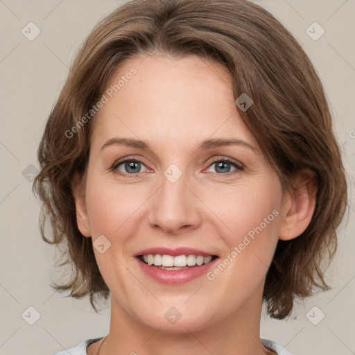 Joyful white young-adult female with medium  brown hair and green eyes