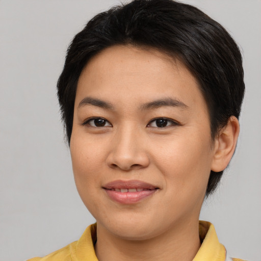 Joyful asian young-adult female with medium  brown hair and brown eyes
