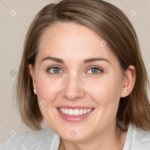 Joyful white young-adult female with medium  brown hair and blue eyes