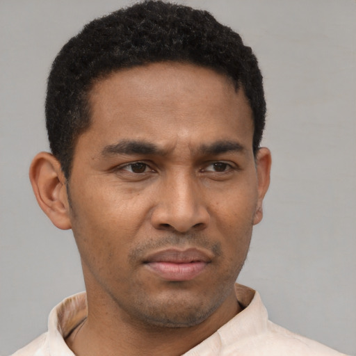 Neutral latino young-adult male with short  black hair and brown eyes