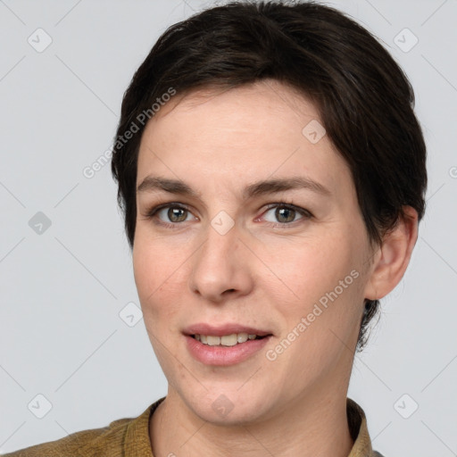 Joyful white young-adult female with short  brown hair and grey eyes