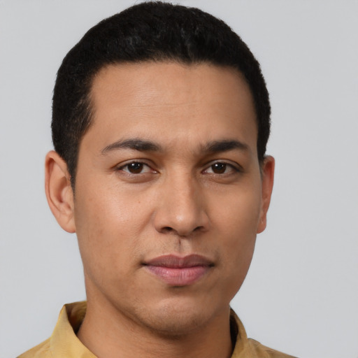 Joyful latino young-adult male with short  brown hair and brown eyes