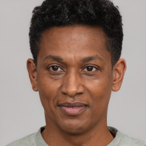 Joyful latino adult male with short  black hair and brown eyes
